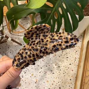 Detail of France Handmade leopard print hair claw with elegant golden lettering