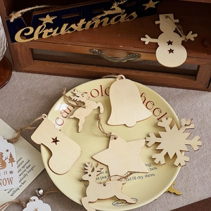 Detailed view of DIY laser-cut wooden Christmas ornaments with reindeer and snowflake shapes