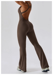 Detail of cross-strap back and high-waist flared hem on a dark brown yoga jumpsuit