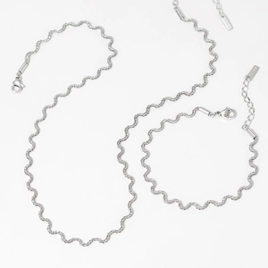 Silver wavy twisted chain necklace and bracelet set with extension tags on white background