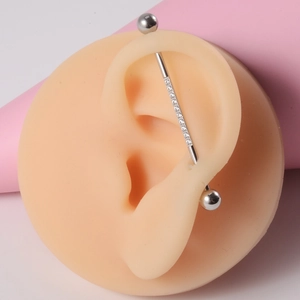 Industrial barbell earring in 14G stainless steel with center-set clear zircon stones