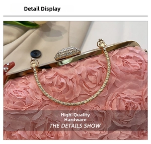 Detail of pink floral evening clutch with rose petals and gold ring handle
