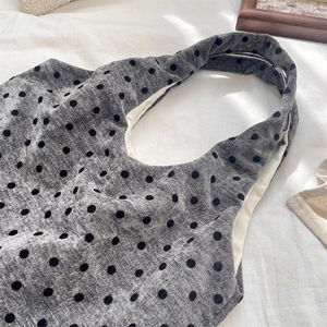 Detailed macro view of the grey polka dot canvas tote with soft velvet-textured dots