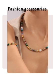 Dettaglio di collana e bracciale con pietre naturali e perle colorate su una modella