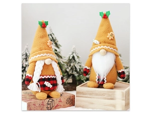 Detail shot of male and female gingerbread gnome plush dolls with festive red plaid accents