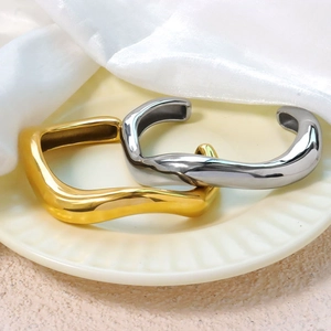Minimalist irregular wavy geometric open bangles in polished gold and silver finish