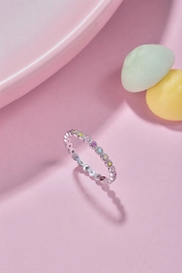 Close-up of S925 sterling silver ring featuring colorful zircon stones on pink background