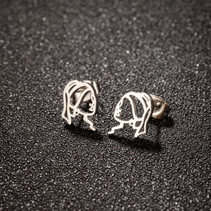 Detailed macro view of silver minimalist abstract face earrings with a metallic finish