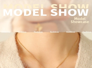 Close-up of golden wave pattern necklace with butterfly pendant on model's neck