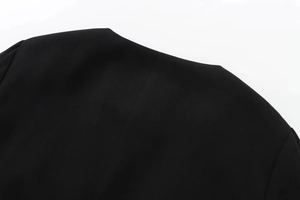 Close-up of high-quality black twill fabric stitching and seams on shoulder detail