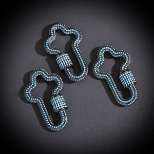 Macro shot of three black metal clover hooks with micro-paved sky blue stones