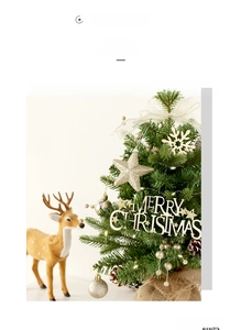 Close-up of mini Christmas tree with LED lights, festive ornaments and a cute reindeer figurine