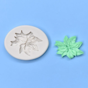 Macro detail of oval leaf and flower silicone mold with green clay craft sample