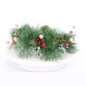 Christmas pine needle wreath with red berries, pine cones and snow for front door decor