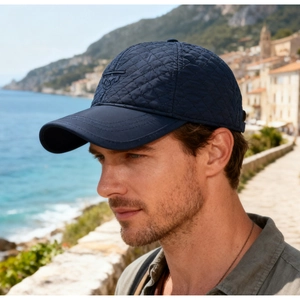 Detail of navy blue quilted baseball cap with nautical anchor embroidery and warm fabric