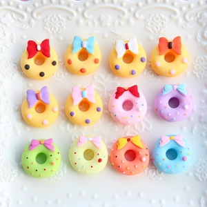 Flat lay of colorful matte resin bow donuts on a relief ceramic tray for DIY crafts