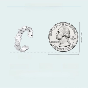 Detail view of 6mm S925 silver puzzle ring with coin for scale on blue background