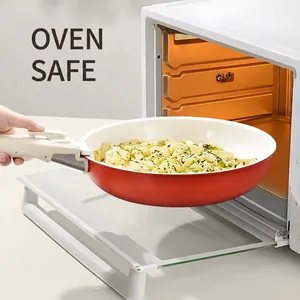 Red non-stick pan with detachable handle shown entering oven with cooked pasta inside