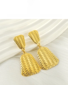 Detail of 18K gold plated drop earrings featuring modern woven fishbone geometric texture