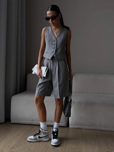 Detail of grey V-neck vest and matching tailored shorts in high-quality suit fabric