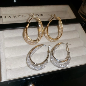 Minimalist double-layered oval mesh drop earrings in gold and silver finish with glitter texture