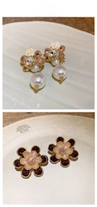 Detail of crystal flower earrings featuring white resin roses and purple petals with pearls