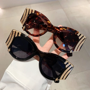 Vintage cat-eye sunglasses in black and tortoiseshell finish with luxury rhinestone temples