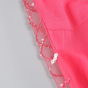 Detailed view of pink evening dress featuring heavy beadwork and sparkling sequins