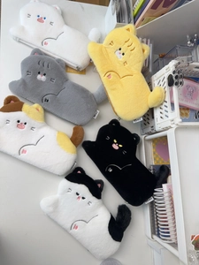 Close-up of cute plush cat pencil cases in various colors with embroidered facial details