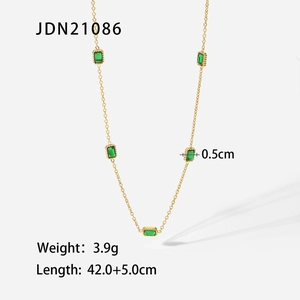 Detail view of 14K gold stainless steel necklace with green zircon gems and measurements