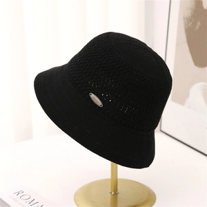 Detail of black crochet knit bucket hat showing breathable texture and metal logo