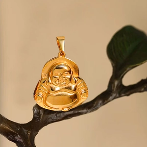 Golden Laughing Buddha Maitreya pendant necklace with high-gloss finish on a wooden branch