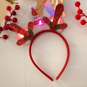 Close-up of glowing LED Christmas headband with red glitter antlers and festive hat