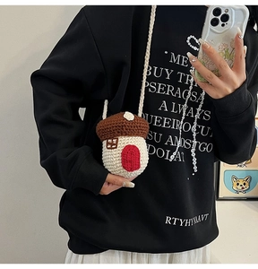 Detailed knit texture of mushroom-shaped crossbody bag in brown and off-white color