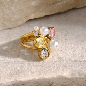 Detailed close-up of 18k gold-plated ring with layered bands and irregular zircon stones