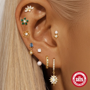 Detailed close-up of S925 sterling silver earrings set with colorful zircon on ear
