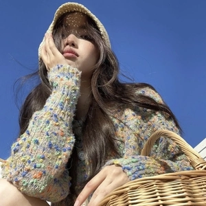 Foldable straw bucket hat for women outdoors with blue sky background