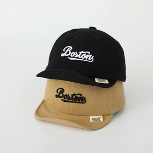 Detail shot of stacked cotton kid baseball caps with Boston embroidery in black and khaki