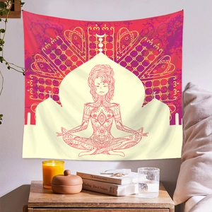 Detail of bohemian mandala tapestry featuring a yoga meditation design in warm bedroom decor