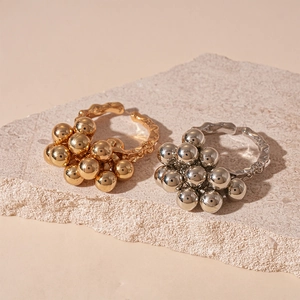 Adjustable geometric ring with gold and silver clustered beads and hammered metal texture