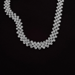 Macro detail of silver-tone choker featuring interlocking links with pave-set zircons