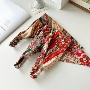 Three vintage paisley and floral print elastic bandanas displayed with home decor