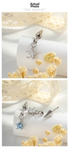 Detailed view of cone bullet back and blue star pendant earrings with zircon stones