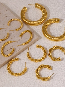 Detailed view of assorted gold-plated titanium steel C-shape earrings with twisted textures