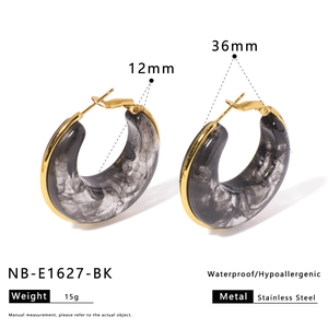 Macro detail of 36mm resin C-hoop earrings with stainless steel posts and size labels