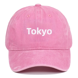 Detail of TOKYO embroidery on washed pink cotton vintage baseball cap with sun protection