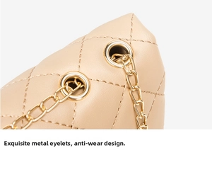 Detail of premium gold hardware eyelet and leather quilting on beige crossbody bag