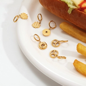 Gold stainless steel food-themed hoop earrings featuring waffles and donuts on a white plate