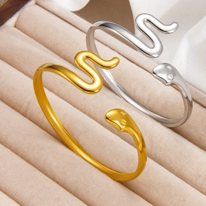 Minimalist snake-shaped open bracelet in gold and silver finish with high-polish texture