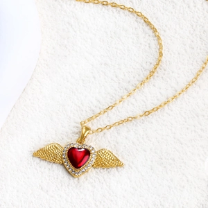 Vintage gold heart necklace with red ruby gemstone and angel wings pendant design
